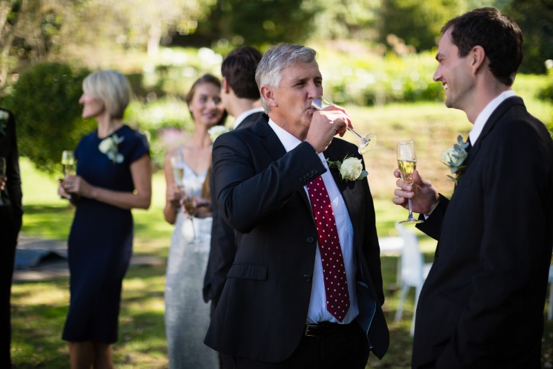 wedding guests talking and drinking champagne in Poland