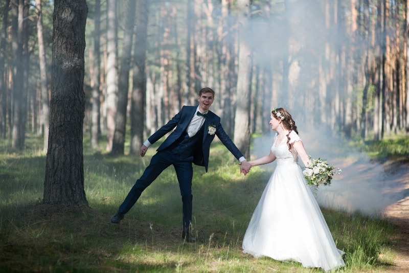 a young couple posing in vast woods