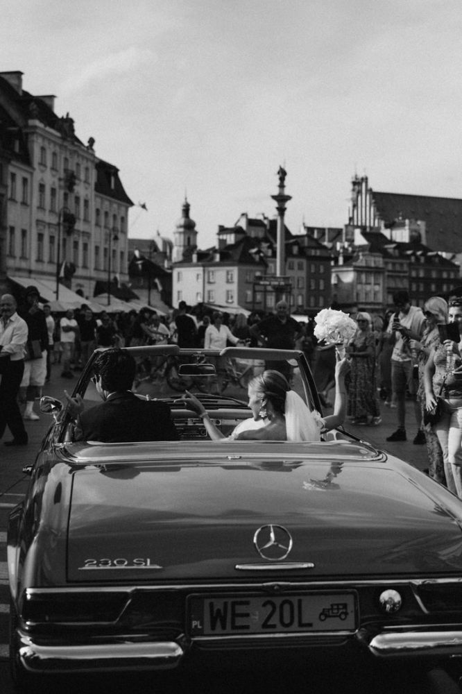 newlyweds in an old car